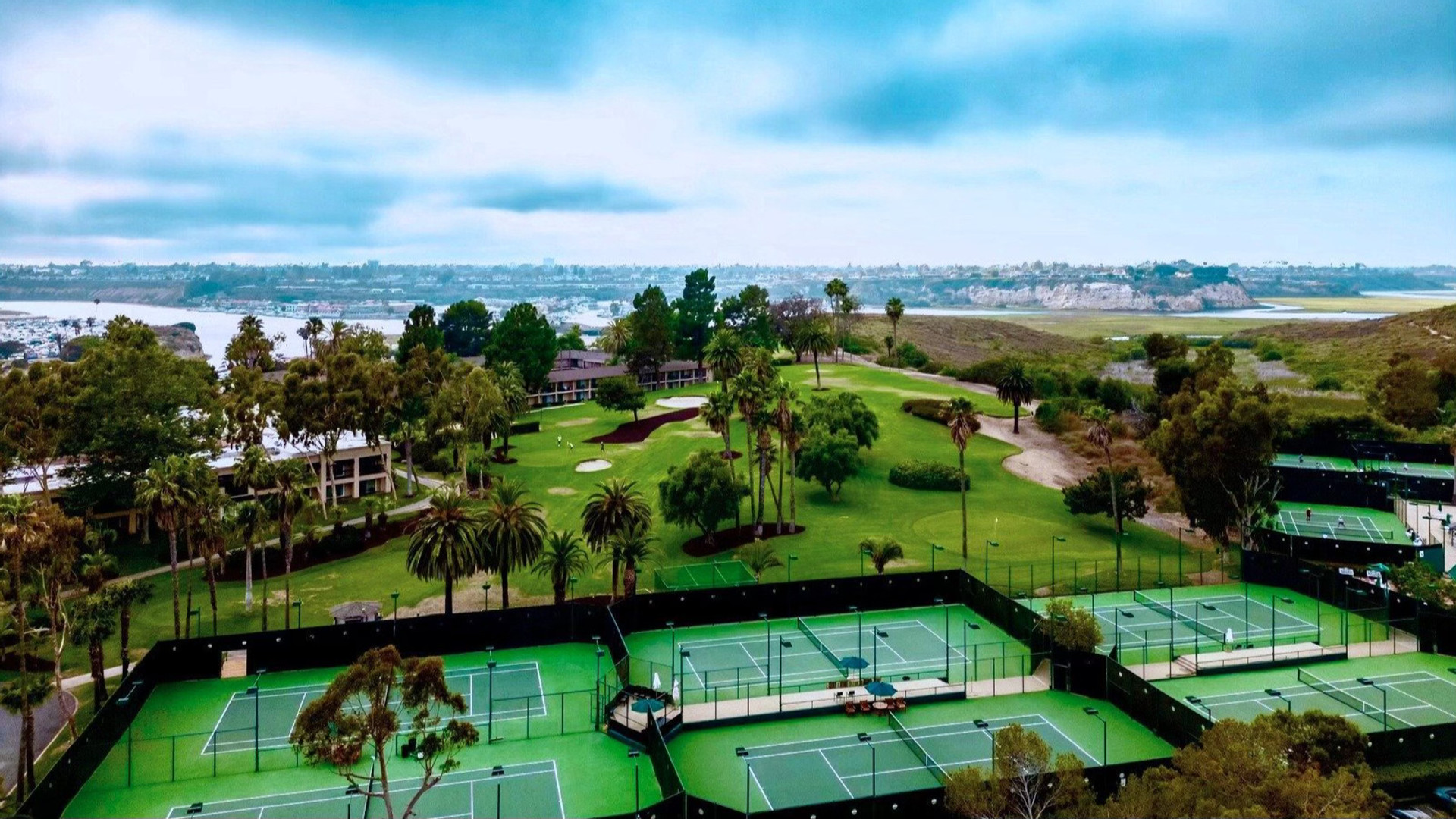 The Newporter Club — aerial view of the courts, golf course, and harbor at the Hyatt Regency Newport Beach